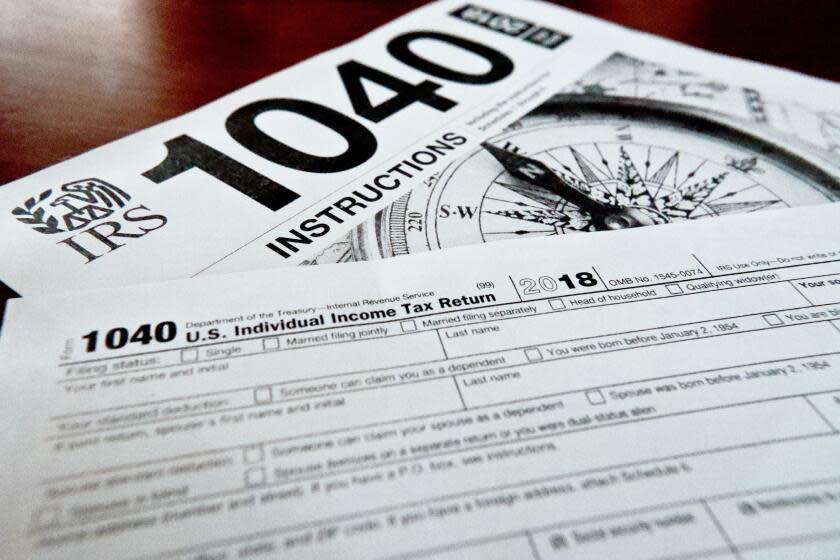 FILE- Internal Revenue Service taxes forms are seen on Feb. 13, 2019. Unlike a deduction, which decreases the income on which you'll be taxed, a tax credit reduces your overall tax due. The result can mean hundreds of dollars knocked off your bill — or added to your refund. (AP Photo/Keith Srakocic, File)