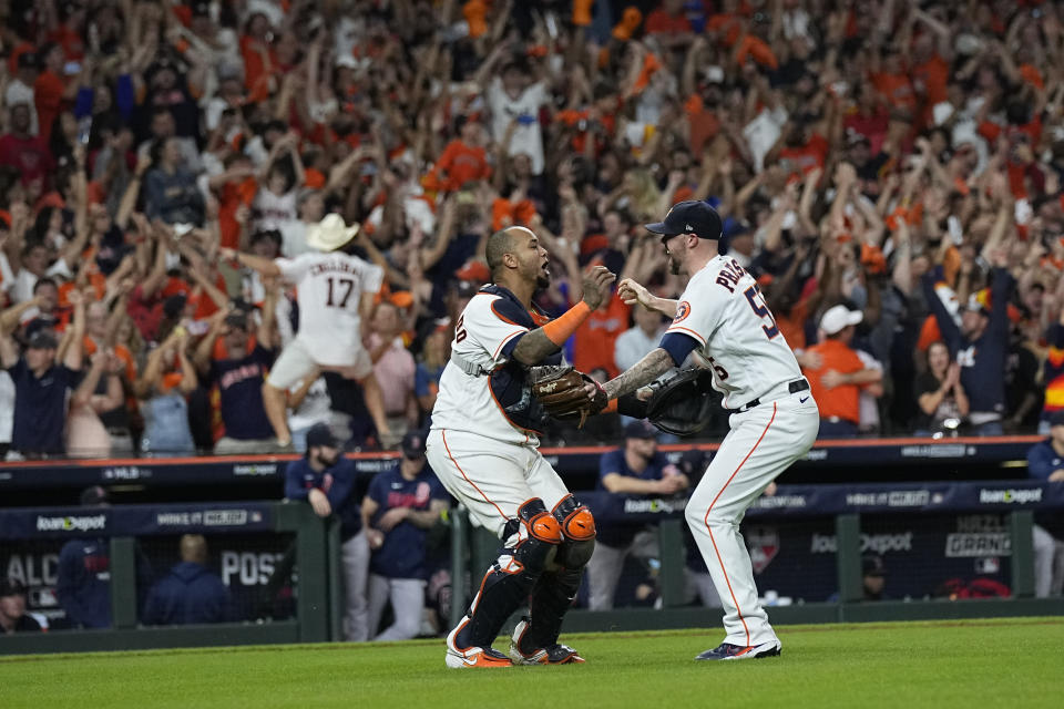 Houston Astros catcher Martin Maldonado and relief pitcher Ryan Pressly celebrate their win against the Boston Red Sox in Game 6 of baseball's American League Championship Series Friday, Oct. 22, 2021, in Houston. The Astros won 5-0, to win the ALCS series in game six. (AP Photo/David J. Phillip)