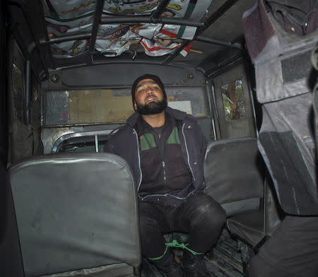 Malik Mumtaz Hussain Qadri, a bodyguard who killed Punjab governor Salman Taseer, is detained at the site of Taseer's shooting in Islamabad, in this January 4, 2011 file picture. REUTERS/Mehdi Shah/Files