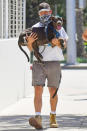 <p>Shia LaBeouf keeps his pup's paws from overheating on the hot sidewalk by carrying him back to his car on Wednesday in Los Angeles. </p>