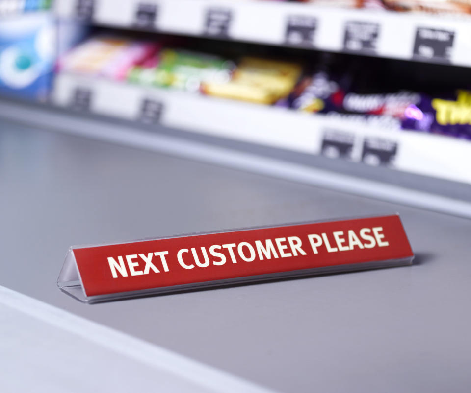 Sign at checkout saying "Next customer please"