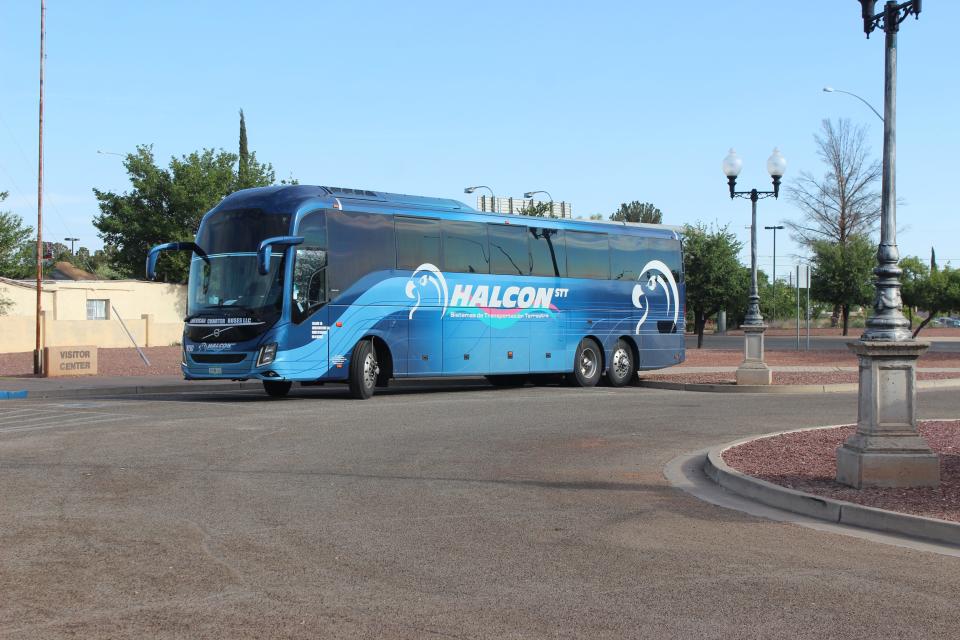 An idling state-run charter bus waits for U.S. Border Patrol to drop migrants off at the Douglas Visitor's Center parking lot on Wednesday, May 17, 2023.