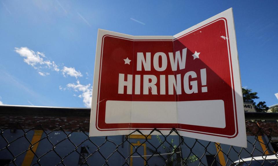 <span>A ‘now hiring’ sign at a business in Somerville, Massachusetts.</span><span>Photograph: Brian Snyder/Reuters</span>