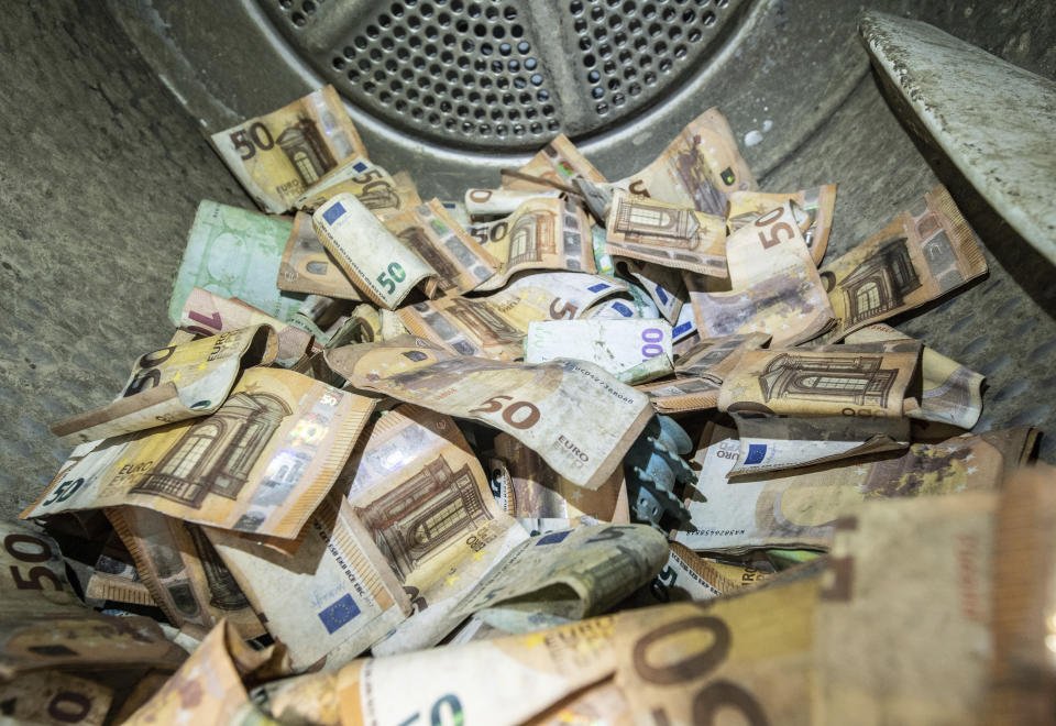 Euro banknotes damaged in the flood disaster are dried in a standard tumble dryer at the Bundesbank in Mainz, Germany, Wednesday, Sept. 1, 2021. Germany’s central bank says it has been inundated with more than 50 million euros’ ($59 million) worth of damaged bank notes after deadly floods that hit part of the country in July. The Bundesbank said Wednesday that individuals and banks have handed in notes that were soaked in the floods and often also contaminated with oil, sewage or mud. (Boris Roessler/dpa via AP)