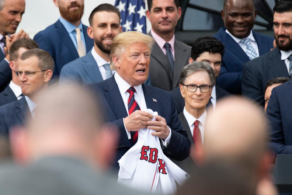 US President Donald Trump (C) holds a Boston Redsox's jersey that was given to him as he welcomed the 2018 World Series Champions to the White House in Washington, DC, on May 9, 2019. (Photo by Jim WATSON / AFP) (Photo credit should read JIM WATSON/AFP/Getty Images)