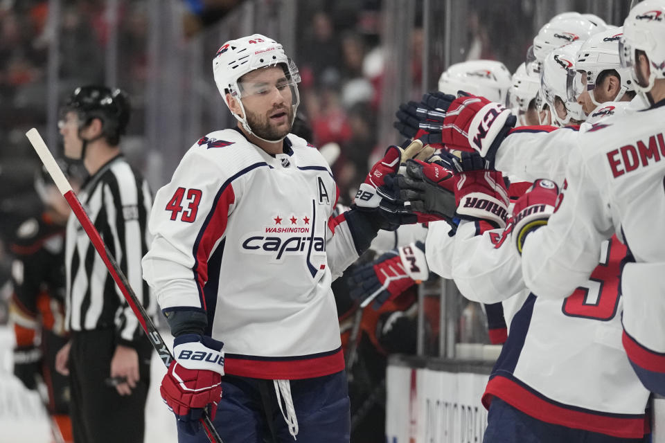 Washington Capitals right wing Tom Wilson (43) celebrates with teammates after scoring during the first period of an NHL hockey game against the Anaheim Ducks in Anaheim, Calif., Thursday, Nov. 30, 2023. (AP Photo/Ashley Landis)