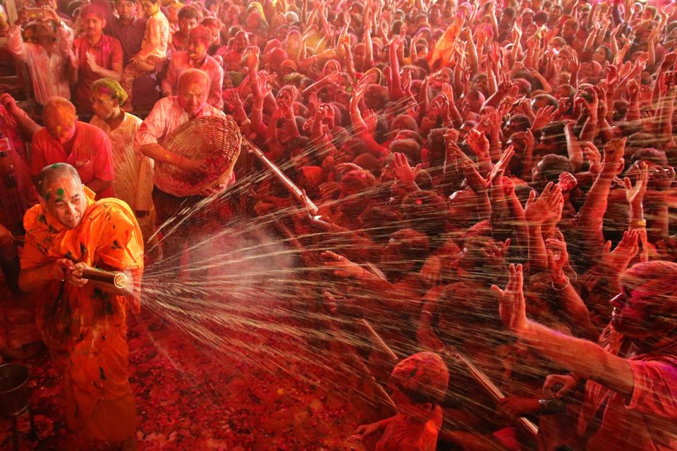<p>Priest water gun on devotees on the occasion of Holi festival celebration at historical Govind Dev Ji temple , in Jaipur, Rajasthan, India on March 1,2018. (Photo: Vishal Bhatnagar/NurPhoto via Getty Images) </p>