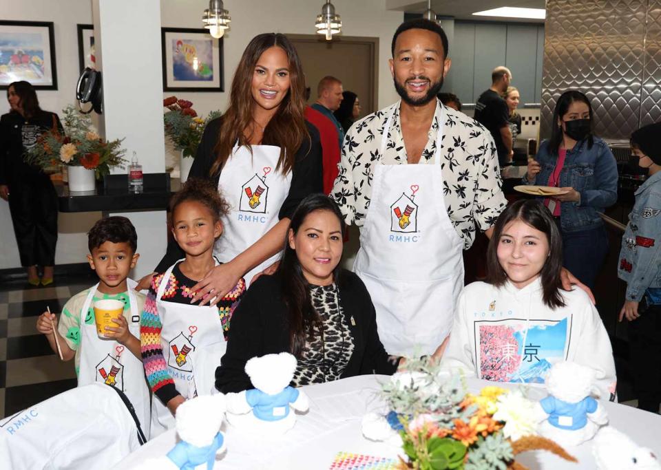 <p>Jerritt Clark/getty</p> John Legend, Chrissy Teigen, Miles, Luna and a family at Ronald McDonald House 