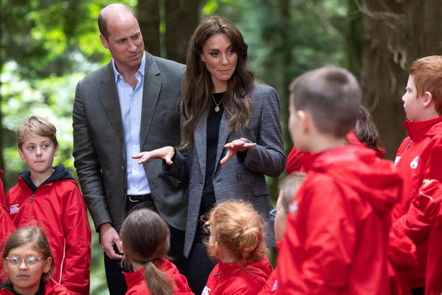 <p>DAVID ROSE/POOL/AFP via Getty Images</p> Prince William with wife Kate meeting kids in a forest in Hereford, on Thursday