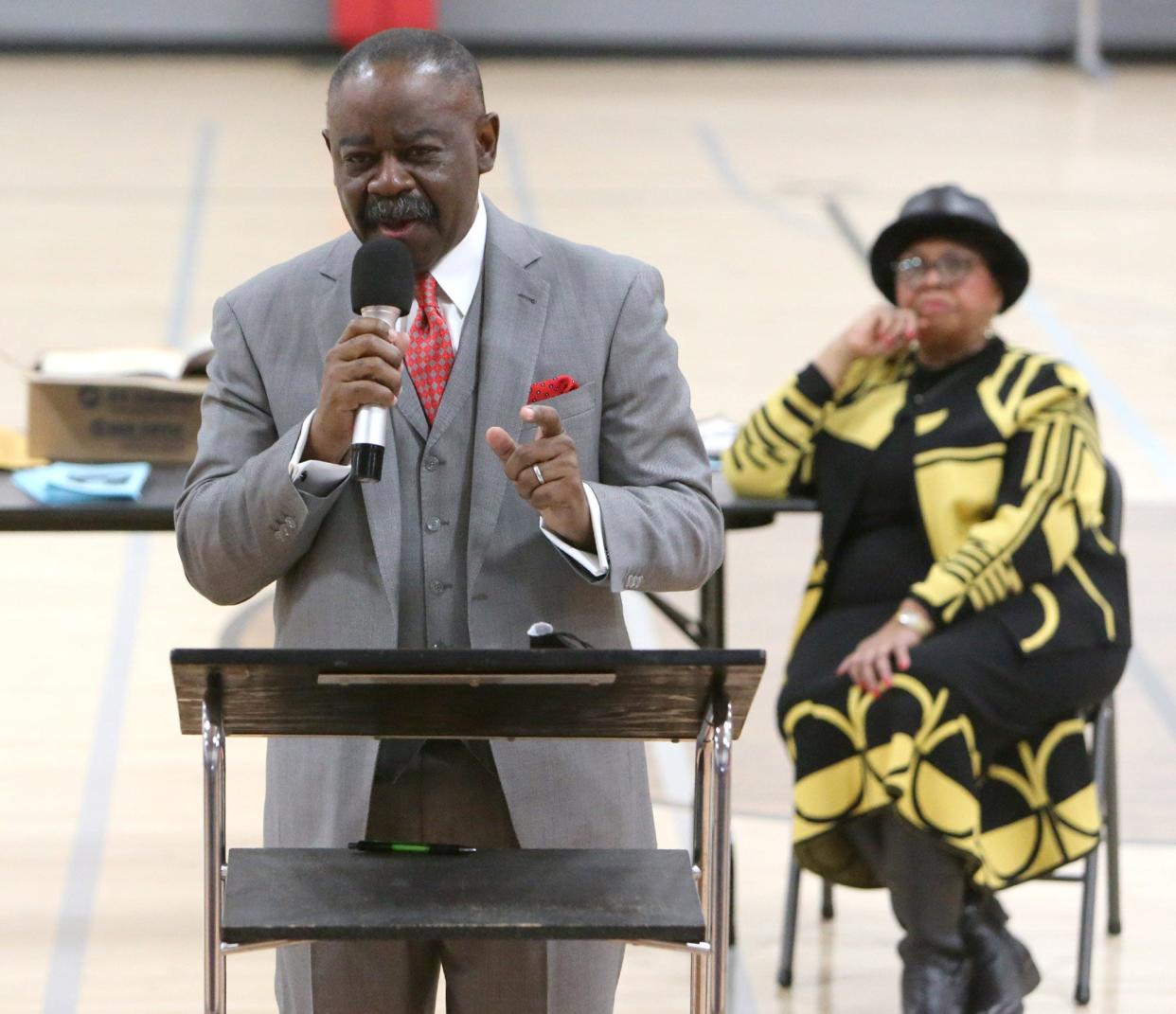 Michael Pressley Sr., pastor of Mt. Zion Church of God in Christ, speaks during the 47th Annual Martin Luther King  Jr. Community Celebration on Saturday at the Edward "Peel" Coleman Center in Canton. In the background is Stephanie Rushin Patrick, co-founder and executive director of the Leila Green Alliance of Black School Educators.