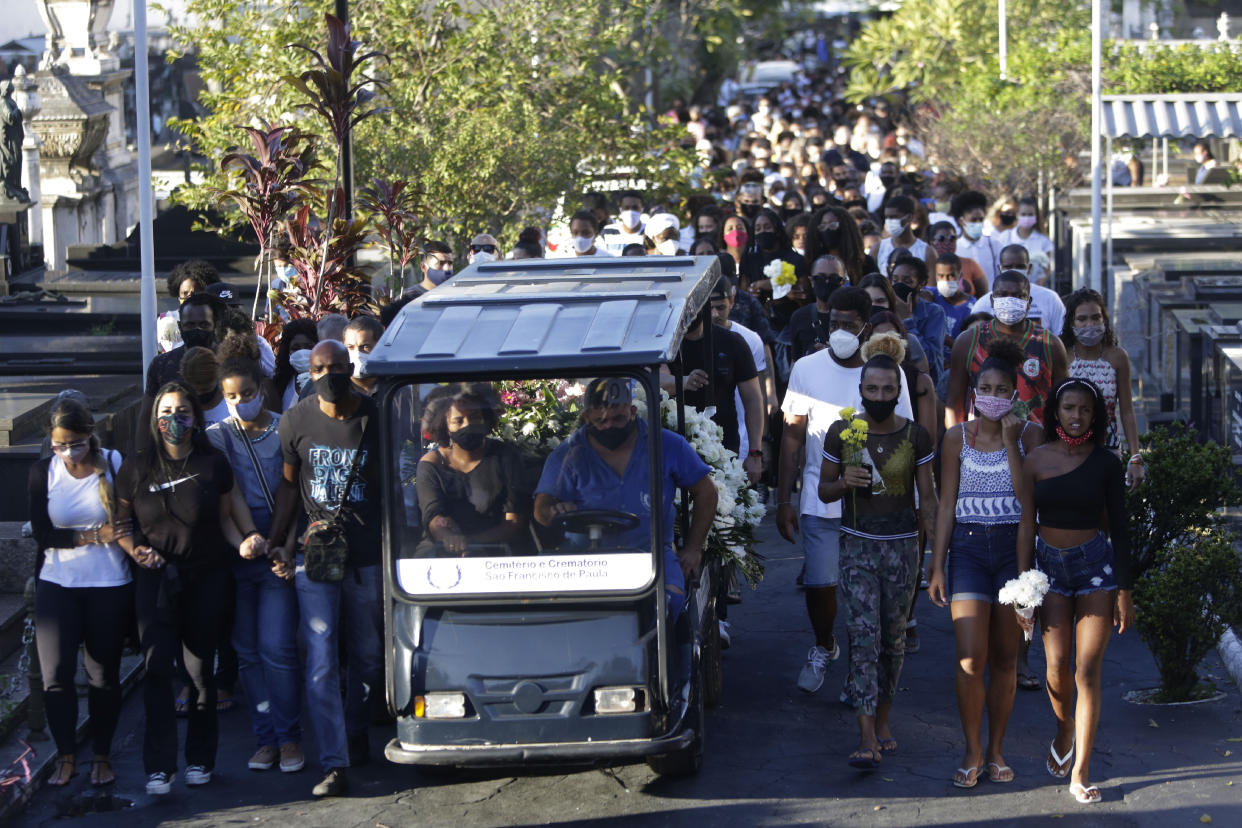 Family and friends accompany the coffin that contain the remains of Kathlen Romeu, a young pregnant woman killed by a stray bullet, at a cemetery in Rio de Janeiro, Brazil, Wednesday, June 9, 2021. Stray bullets have struck at least six pregnant women in Rio since 2017, but Romeu was the first to die, according to Crossfire, a non-governmental data project that tracks armed violence. (AP Photo/Bruna Prado)