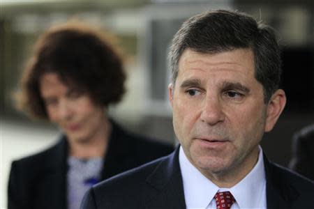 Attorney Aaron Marcu (R) speaks about his client, Raoul Weil, a former high-ranking UBS banker charged with tax fraud by U.S. authorities, who is pending release on bail of $10.5 million at federal court in Fort Lauderdale, Florida December 16, 2013. At left is Susan Lerch Weil, wife of Raoul Weil. REUTERS/Joe Skipper