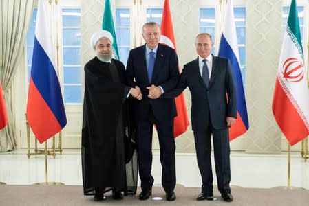 Presidents Hassan Rouhani of Iran, Tayyip Erdogan of Turkey and Vladimir Putin of Russia shake hands during their meeting in Ankara