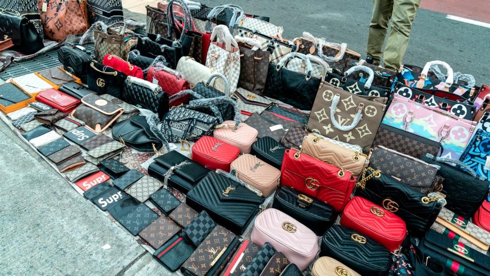 PHOTO: In this Nov. 19, 2020, file photo, street vendors sell counterfeits goods like bags, sunglasses, belts and watches, in New York. (Lev Radin/Sipa USA via AP, FILE)