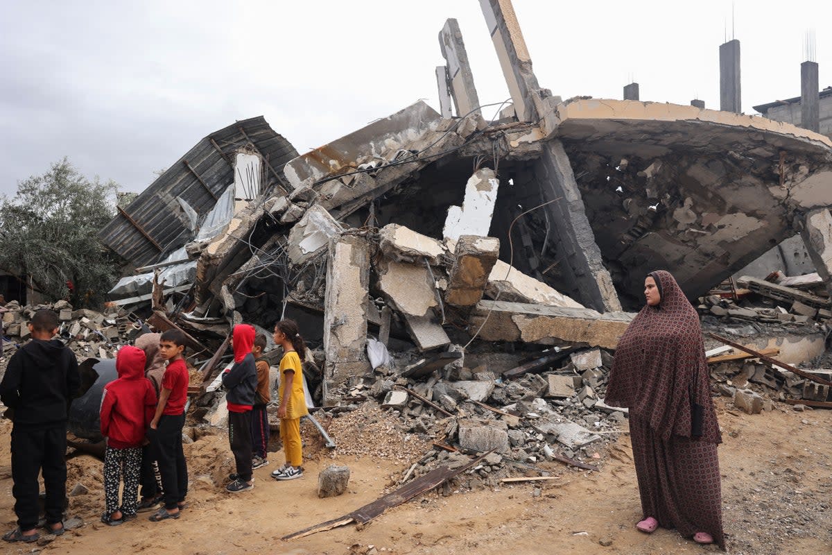 Palestinians inspect the destruction following overnight Israeli strikes on Rafah in the southern Gaza Strip on 6 May (AFP via Getty Images)
