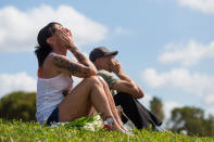 <p>Stacey Sindon, 51, reacts as she mourns in front of Marjory Stoneman Douglas High School in Parkland, Fla. on Sunday, Feb. 18, 2018. A gunman entered the school last Wednesday and killed 17 students and teachers. (Photo: Matias J. Ocner/Miami Herald/TNS via Getty Images) </p>