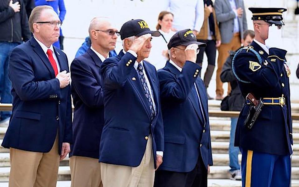 Chief George Farrell, Chairman of the RI Honor Flight program, left, salutes during wreath-laying ceremony at the Tomb of the Unknown Soldiers during a previous trip.