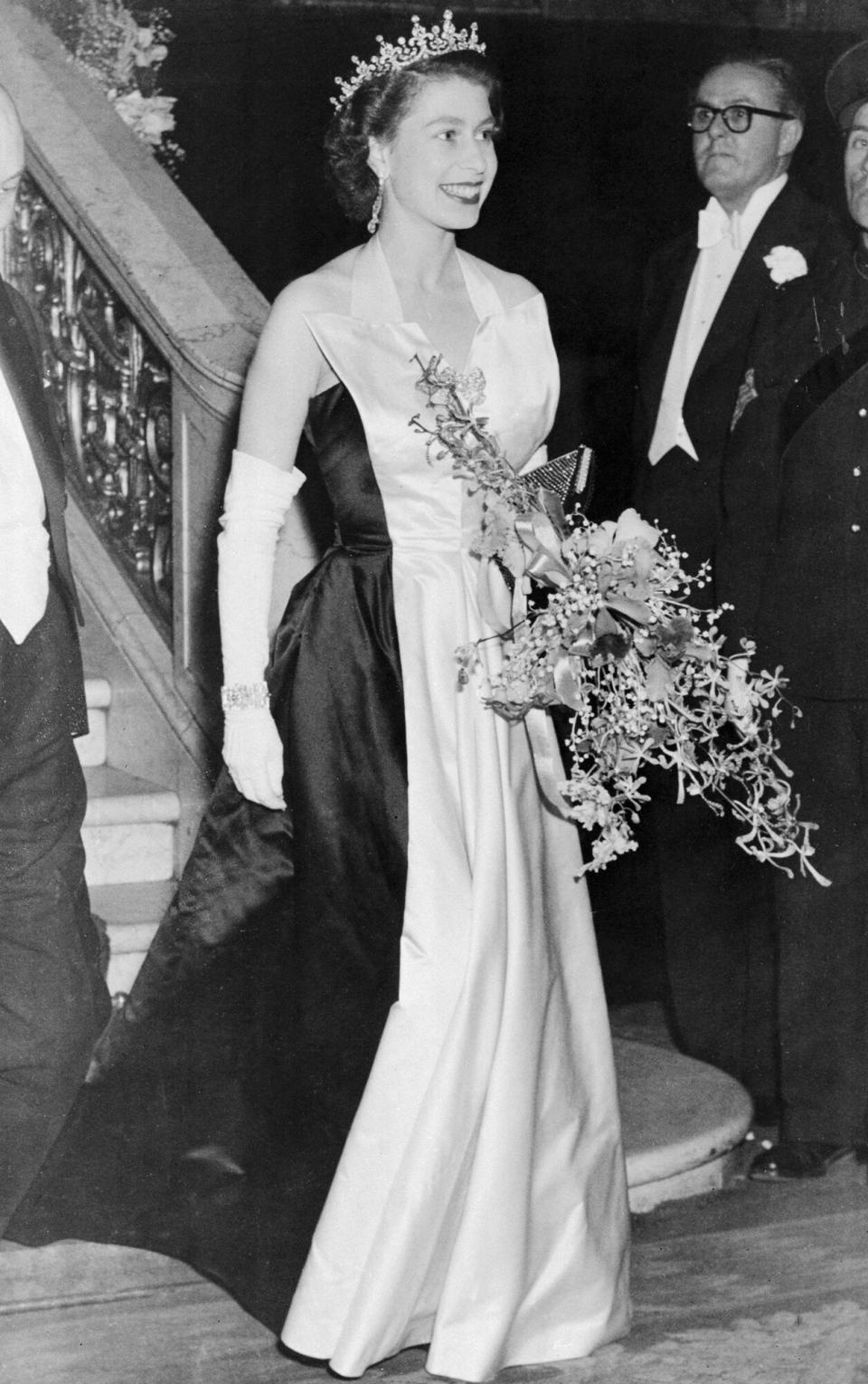 Queen Elizabeth II leaves the Empire Theater in Leicester Square after attending the Royal Film Show. The movie was a musical, titled Because You're Mine.