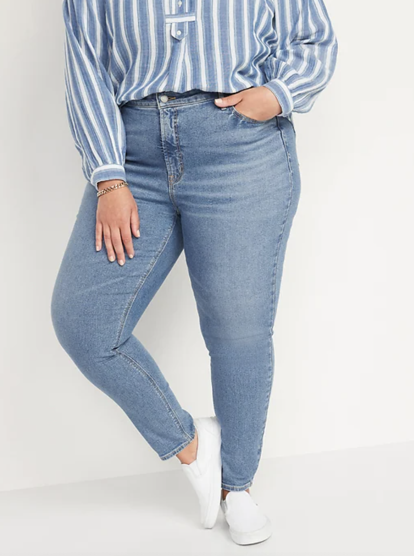 plus size model wearing white sneakers and High-Waisted Rockstar Super Skinny Jeans