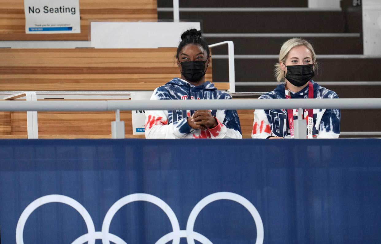 Simone Biles, left, and MyKayla Skinner watch the men's all-around final at the Tokyo Olympics.
