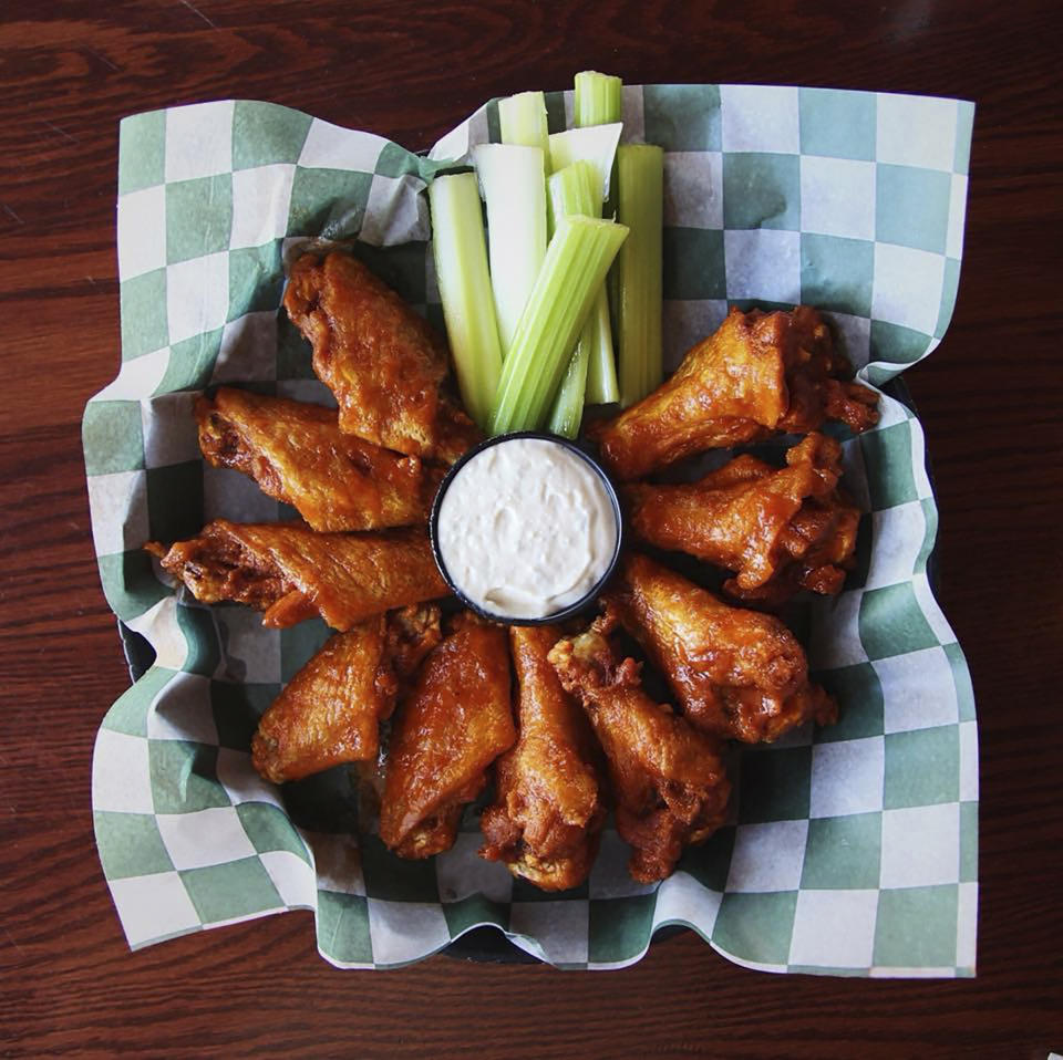 This photo is provided by Visit Buffalo Niagara. Sauce at the Bar-Bill is painted on each wing with paint brushes, and always served in batches of exactly five drumsticks and five flat wings. (Drew Brown/Buffalo Niagara via AP)