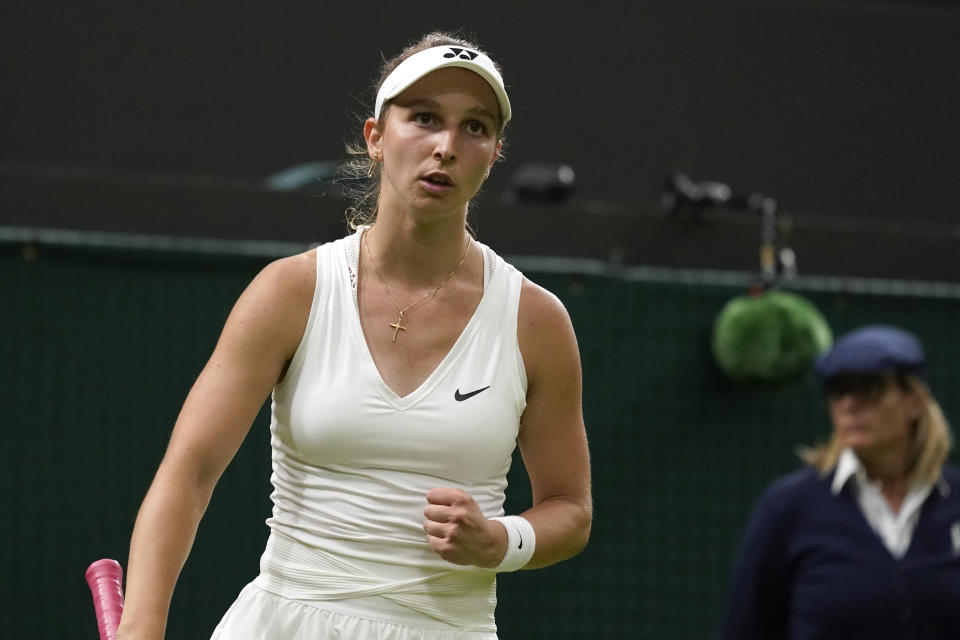 Germany's Tamara Korpatsch celebrates winning a point Britain's Heather Watson during their women's singles tennis match on day one of the Wimbledon tennis championships in London, Monday, June 27, 2022. (AP Photo/Alberto Pezzali)