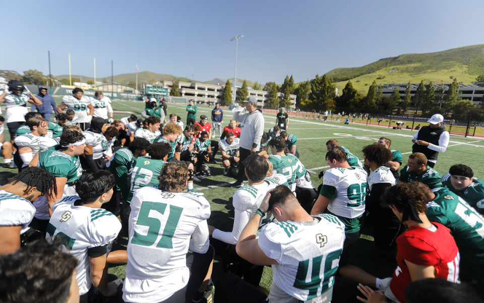 Coach Paul Wulff speaks to the players during the Cal Poly football team’s spring practices at Doerr Family Field on April 14, 2023.