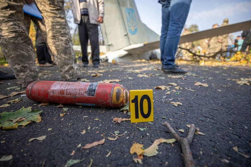 Investigators work at a crash site of the Ukrainian military Antonov An-26 aircraft outside Chuhuiv