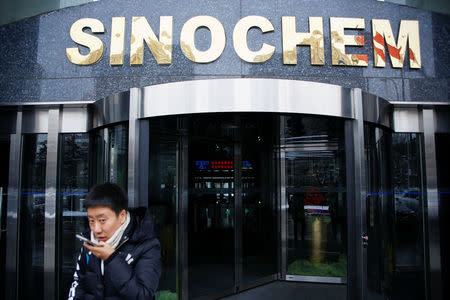 A man walks past the office building of Sinochem in Beijing, China February 21, 2017. REUTERS/Damir Sagolj