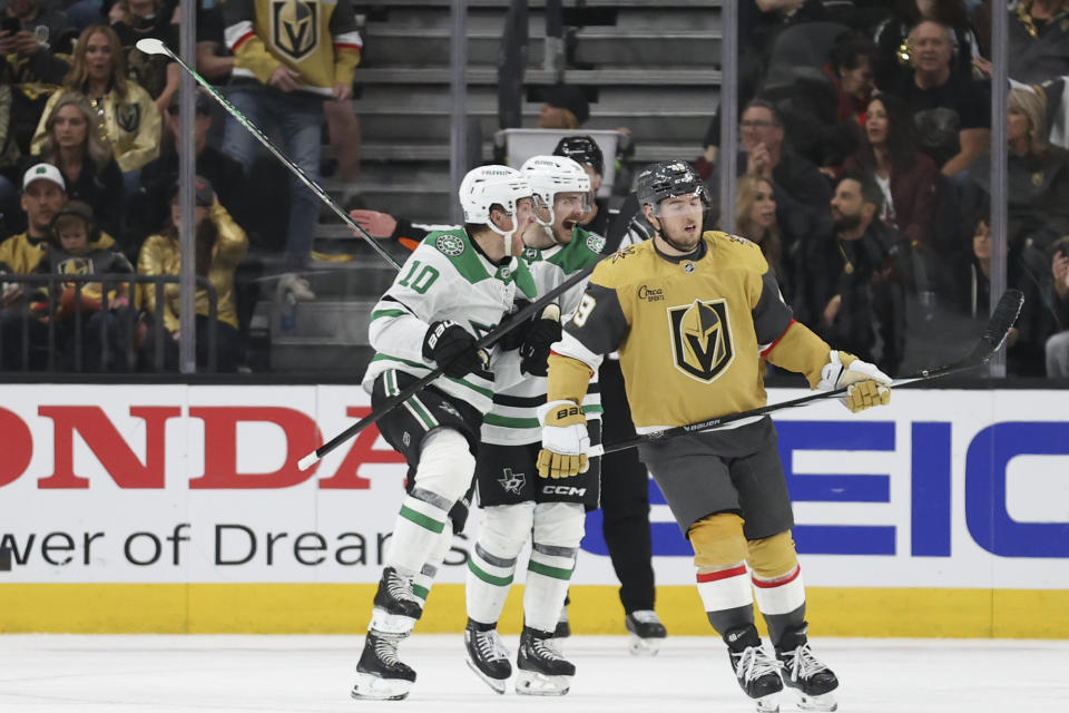 Dallas Stars centers Ty Dellandrea (10) and Sam Steel (18) celebrate after Dellandrea's goal while Vegas Golden Knights center Ivan Barbashev (49) reacts during the second period in Game 4 of an NHL hockey Stanley Cup first-round playoff series Monday, April 29, 2024, in Las Vegas. (AP Photo/Ian Maule)