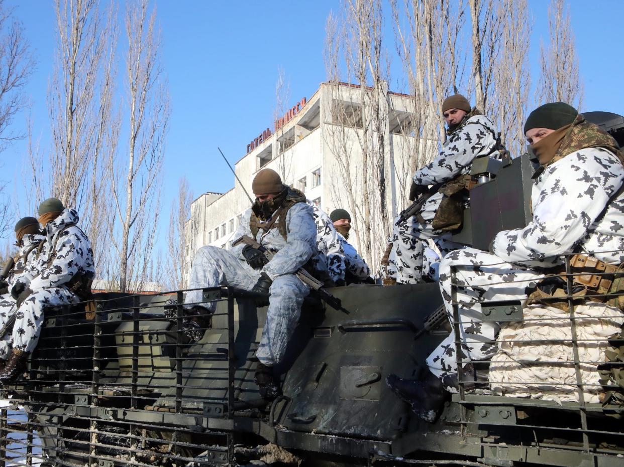 Soldiers sit inside the Chernobyl Exclusion Zone