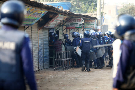 Police chase garments worker who has been protesting for higher wages at Ashulia, outskirt of Dhaka, Bangladesh, January 14, 2019. REUTERS/Mohammad Ponir Hossain