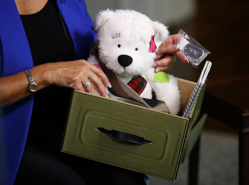 Karen Pence holds a Comfort Crew Kit to be given to a military child during an interview with The Associated Press at the Vice President's residence, the Naval Observatory, in Washington, Monday, Sept. 10, 2018. “Now people take my phone calls,” Karen Pence told The Associated Press in an interview. These days, Vice President Mike Pence’s wife is using her new cachet to call around on behalf of military spouses, looking to help them overcome the challenges that come with being wed to an active-duty service member.(AP Photo/Carolyn Kaster)