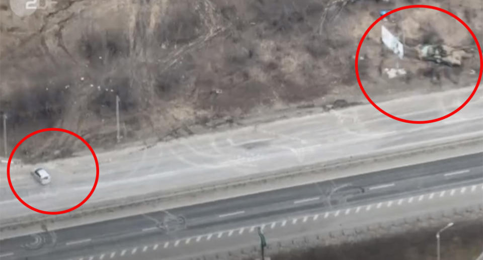 The drone footage captured the silver car (left) was travelling towards the centre of Kyiv when they are believed to have spotted the Russian tanks (right).  