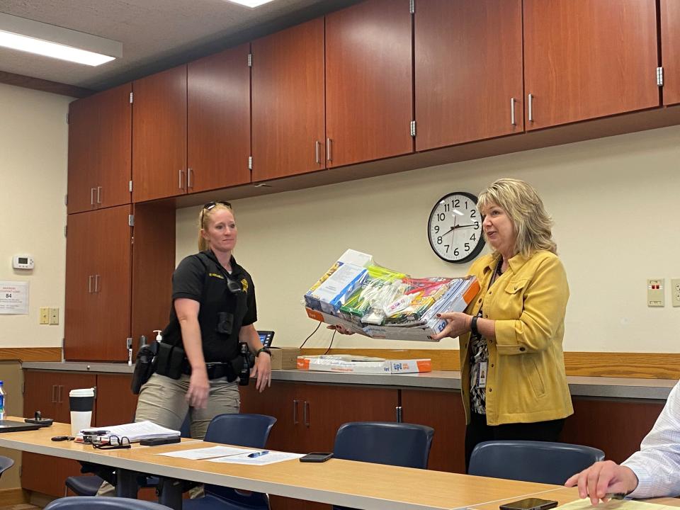 Sue Scott, communications coordinator for TSC, holds up one of the supply kits that will be provided to K-8 TSC students. June 8, 2022