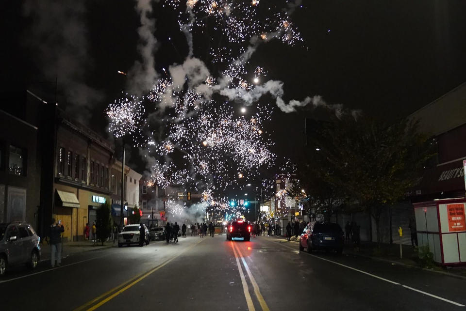 Fireworks explode in the sky during a protest in response to the police shooting of Walter Wallace Jr., early Tuesday, Oct. 27, 2020, in Philadelphia. Police officers fatally shot the 27-year-old Black man during a confrontation Monday afternoon in West Philadelphia that quickly raised tensions in the neighborhood. (Jessica Griffin/The Philadelphia Inquirer via AP)