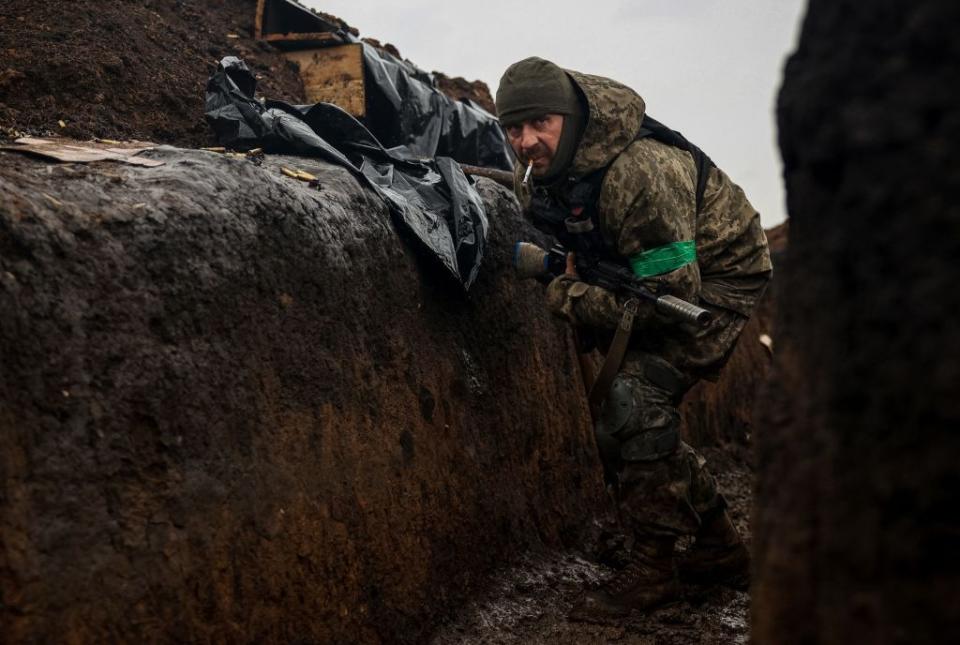 A Ukrainian infantryman of the 57th Separate Motorized Infantry Brigade takes cover in a trench at an undisclosed location near the town of Bakhmut, Donetsk Oblast, on April 13, 2023. (Anatolii Stepanov/AFP via Getty Images)