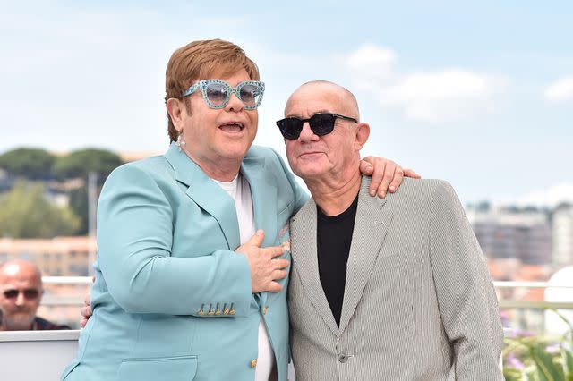 <p>Dominique Charriau/WireImage</p> Elton John and Bernie Taupin in Cannes in May 2019