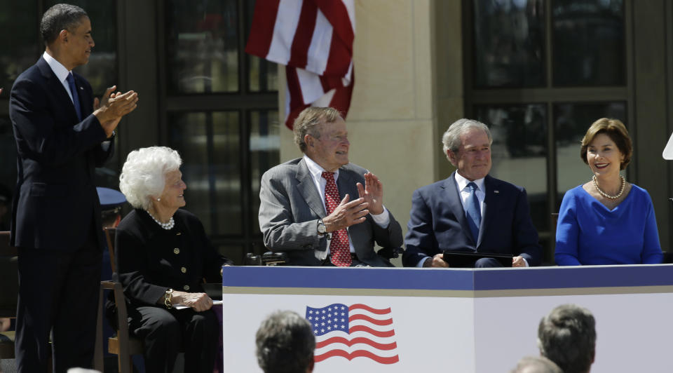 From left, President Barack Obama, former first lady Barbara Bush, former president George H.W. Bush and Laura Bush applaud former president George W. Bush after his speech during the dedication of the George W. Bush presidential library on Thursday, April 25, 2013, in Dallas. (AP Photo/David J. Phillip)