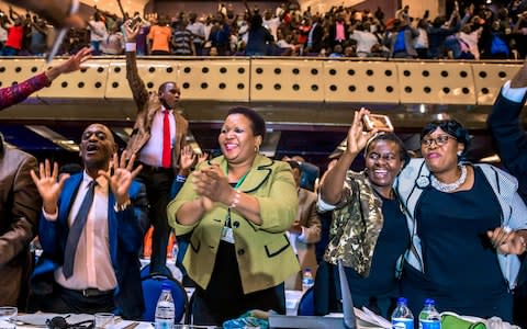 Parliament erupts after the announcement  - Credit: JEKESAI NJIKIZANA/AFP