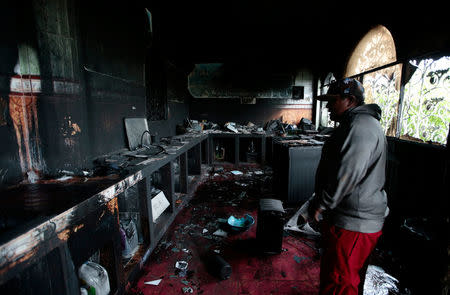 A man stands inside a burned house where, according to local media, six people died, during a protest against Nicaragua's President Daniel Ortega's in Managua, Nicaragua June 16, 2018.REUTERS/Oswaldo Rivas