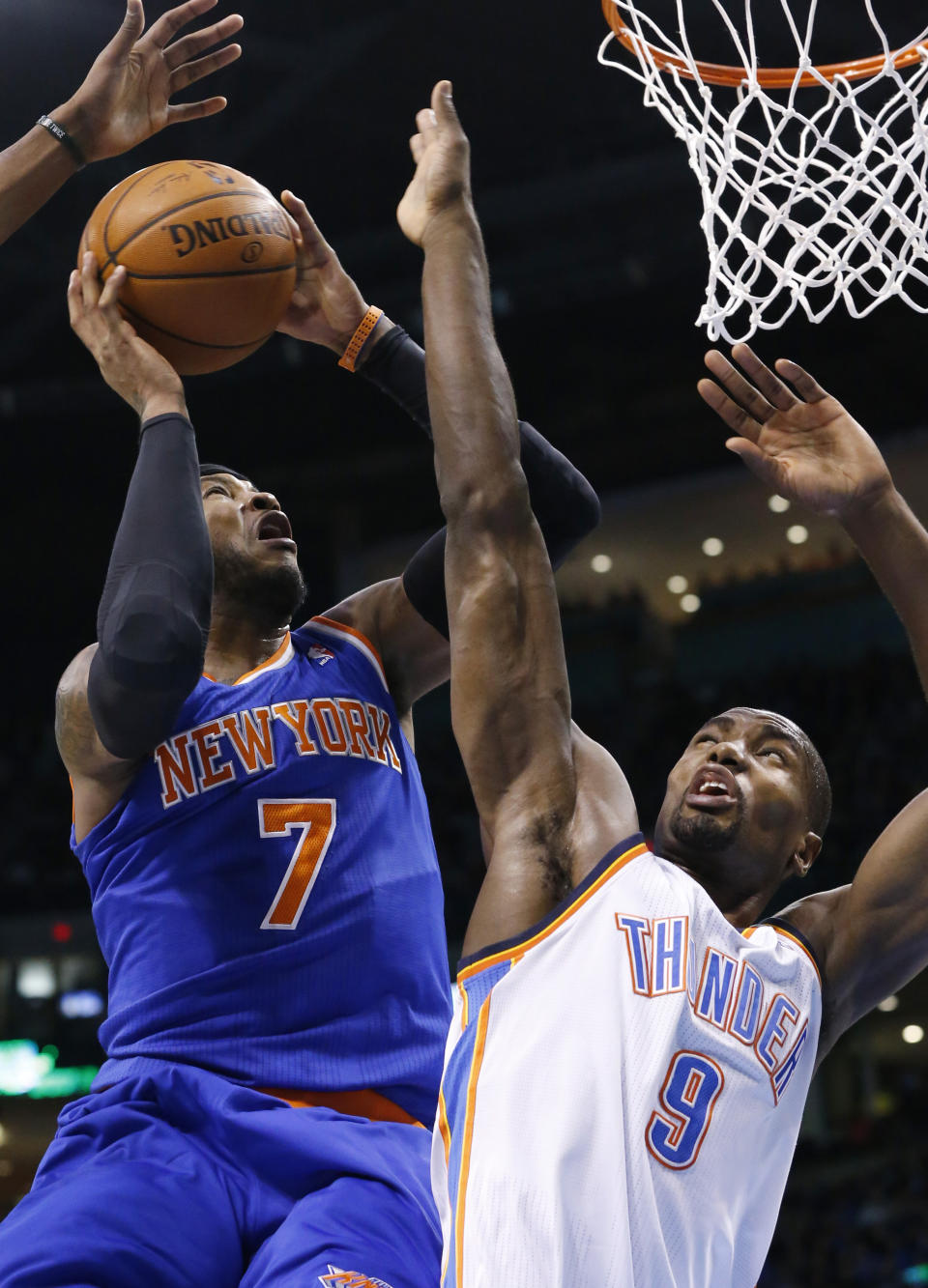 New York Knicks forward Carmelo Anthony (7) shoots over Oklahoma City Thunder forward Serge Ibaka (9) in the first quarter of an NBA basketball game in Oklahoma City, Sunday, Feb. 9, 2014. (AP Photo/Sue Ogrocki)