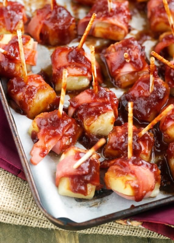 <p>Food Faith Fitness</p><p>Bacon-wrapped pineapple chunks are coated in a sticky sauce for a sweet and smokey flavor combo.</p><p><strong>Get the recipe: <a href="https://www.foodfaithfitness.com/sweet-n-sour-bacon-wrapped-pineapple/" rel="nofollow noopener" target="_blank" data-ylk="slk:Sweet 'n Sour Bacon Wrapped Pineapple;elm:context_link;itc:0;sec:content-canvas" class="link ">Sweet 'n Sour Bacon Wrapped Pineapple</a></strong></p>