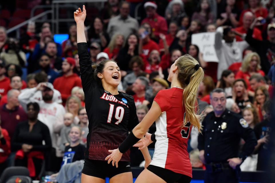 Louisville's Elena Scott (19) celebrates with teammate Nena Mbonu (3) following their NCAA Regional Final game against Oregon, Saturday, Dec. 10 2022 in Louisville Ky. Louisville will now advance to the Final Four.