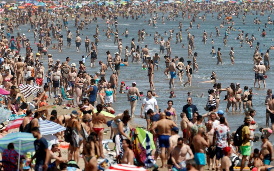 Beachgoers enjoy a sunny day on Malvarrosa Beach in Valencia, eastern Spain - KAI FOERSTERLING/EPA-EFE/Shutterstock