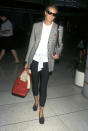 <p>Catching a flight from Los Angeles, Macpherson opts for an oversized grey blazer with skin-tight jeans, 1997</p>