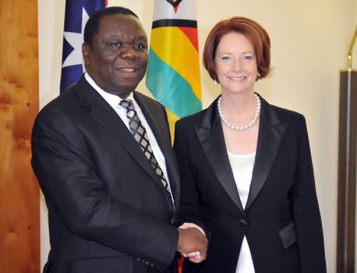 Zimbabwean Prime Minister Morgan Tsvangirai is greeted by Australian Prime Minister Julia Gillard before their official meeting at Parliament House in Canberra, on July 23. Zimbabwe is ready to re-engage with the global community, Tsvangirai said during his visit