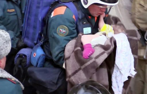 Rescuers dug out a 10-month-old boy in what officials described as a "New Year's miracle" with 37 people confirmed dead from the apartment block blast