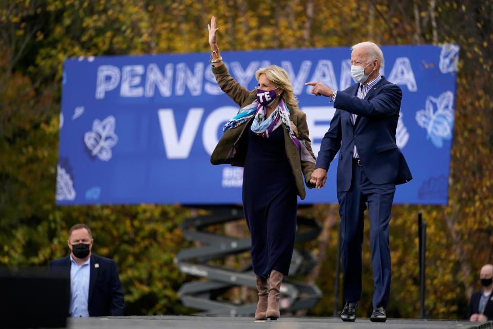 Democratic presidential candidate Joe Biden and his wife, Jill, arrive at a campaign stop at Bucks County Community College on Oct. 24 in Bristol, Pa., where the former vice president faced hecklers chanting, "Four more years."