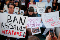 <p>Protesters hold signs at a rally for gun control at the Broward County Federal Courthouse in Fort Lauderdale, Fla., Feb. 17, 2018. (Photo: Rhona Wise/AFP/Getty Images) </p>